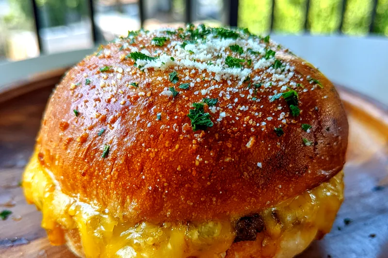 An array of fresh ingredients for Savory Garlic Cheeseburger Bites, including beef, cheese, and spices.